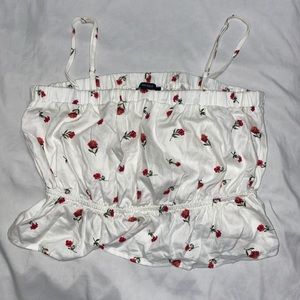 white tank top with roses and poof at the bottom